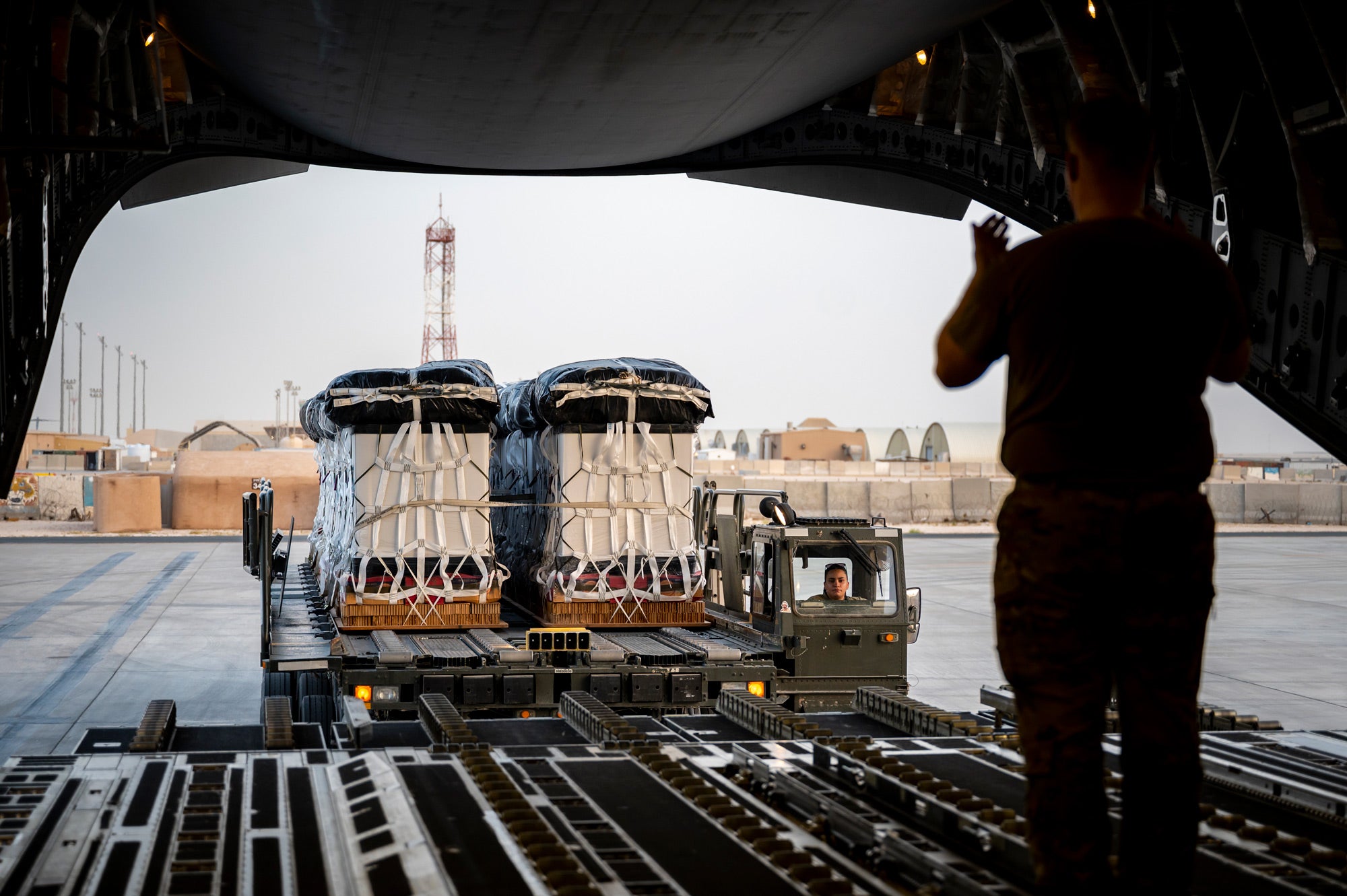 The LCADS low velocity parachutes are rigged on top of the payloads along with the low cost container net. They are ready to be rolled onto the plane for airdrop. Somewhere in Qatar.