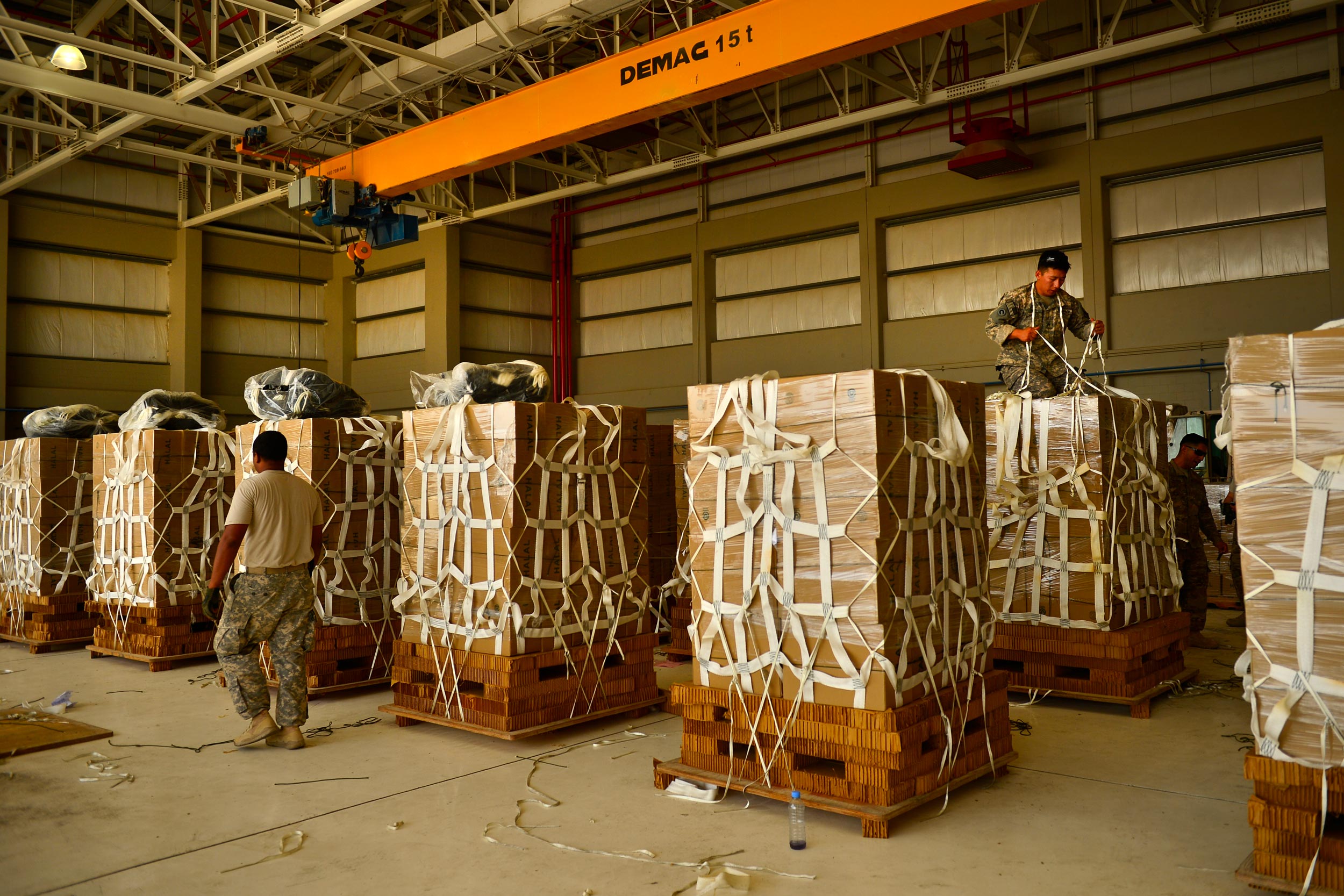 Multiple payloads are lined up and prepared for a cargo parachute delivery for humanitarian aid. The high velocity parachutes are stacked on top of the cargo and the low cost container wraps around the cargo where the parachute will be connected. Rigged in Jordan airdropped in Syria.