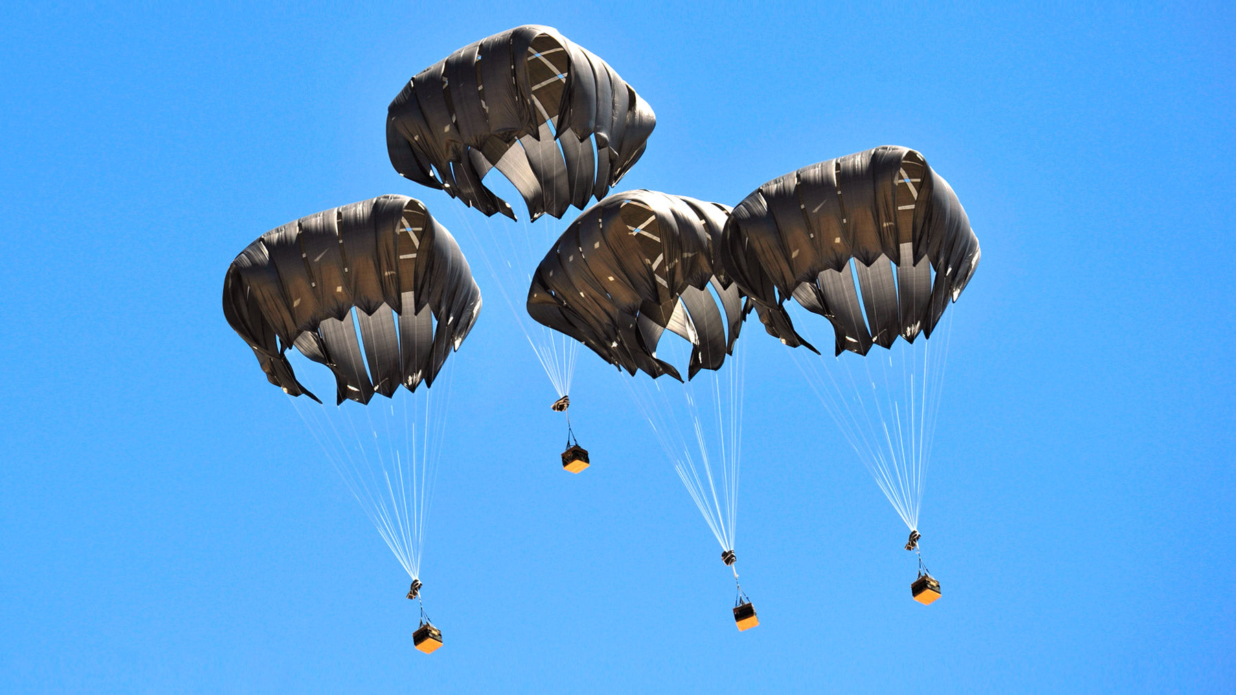 Low Velocity Parachutes fully deployed each carrying individual payloads. Manufactured by Niche Inc